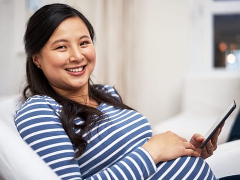 These pregnancy blogs are filled with helpful advice. Portrait of a pregnant woman using a digital tablet at home