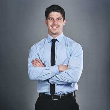 Its time to level up on my success. Studio portrait of a young businessman posing against a grey background