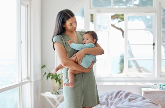 Mother, baby and holding kid in home for love, care and quality time together for childcare, growth and development. Mom, infant and carrying newborn girl in arms for support, comfort or nursery room.