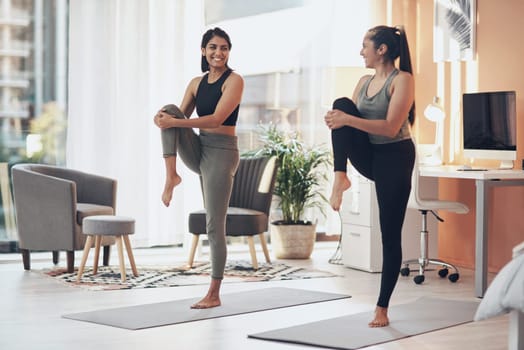 Friends, exercise and women stretching together in a house with a smile, health and wellness. Indian sisters or female family in a home while happy about workout, yoga and fitness with a partner.