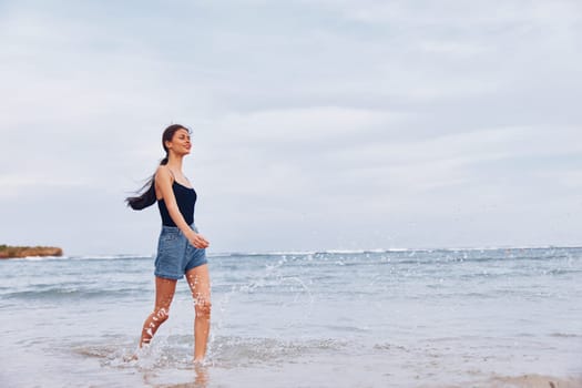 woman beautiful smile sea lifestyle hair summer smiling running fun happiness sunset long active beach walking young flight travel hair person girl