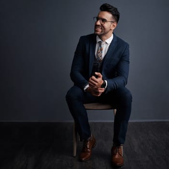 Success is for the visionaries. Studio shot of a stylish young businessman looking thoughtful against a gray background