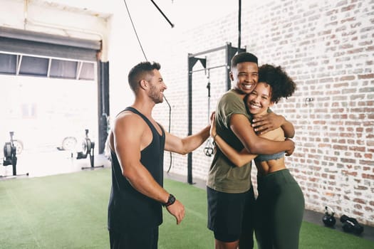 Surround yourself with people who supports you. three sporty young people looking cheerful at the gym