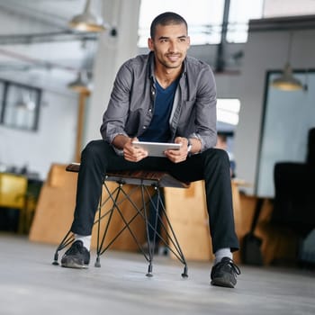 Tablet, thinking and a man designer sitting in his for a creative idea or inspiration while searching online. Technology, research and design with a young male employee using the internet at work.