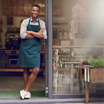 Smile, coffee shop and portrait of a man as small business owner at front door. Happy entrepreneur person as barista, manager or waiter in restaurant for service, career pride and startup goal.