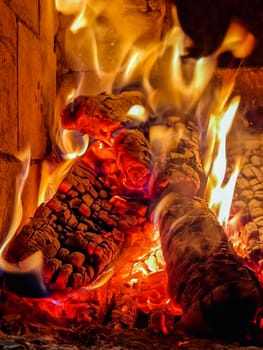 Logs burning in a fireplace stove. Close up.