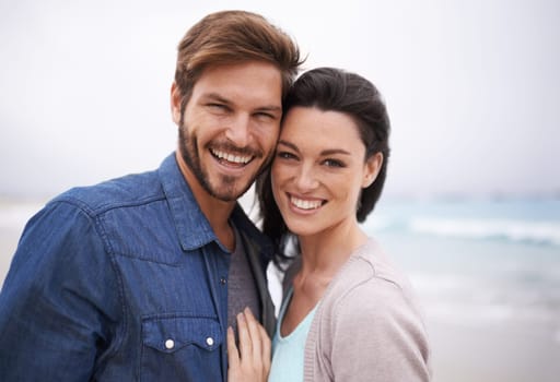 Portrait, hug and couple at a beach with love for travel, romance and freedom together outdoors. Face, smile and happy woman embracing man on trip, vacation or holiday, bond and having fun in Cancun.