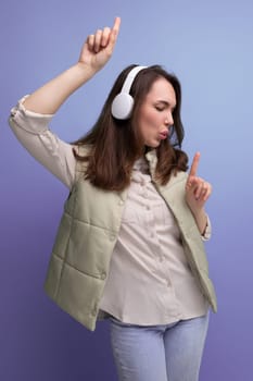 portrait of pretty young brunette woman enjoying music in headphones.