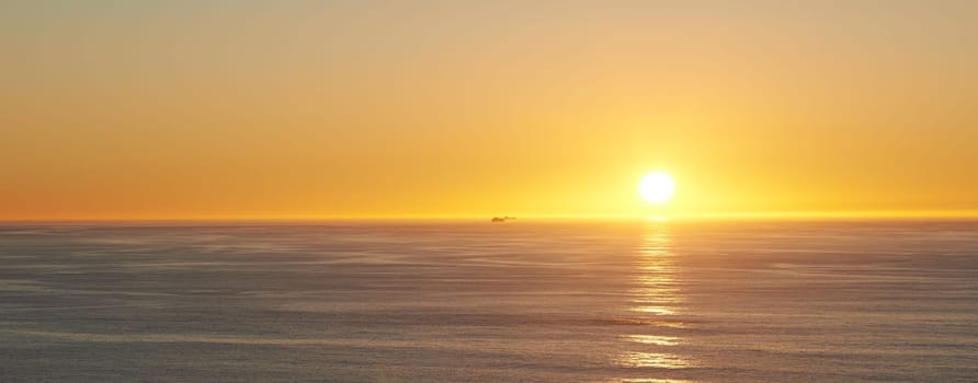 Orange sky, sunset and sea at morning on the horizon with ocean and waves landscape. Sunrise background, calm weather and summer by beach with coastline and outdoor environment with sun and mockup.