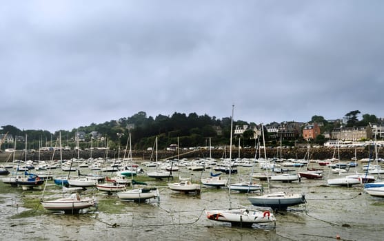 View of the harbor at low tide in the French town of Saint Quay Portrieux with stranded ships.