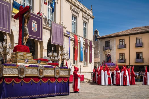 Holy Week in Palencia, Spain. Penitents carrying the image of Jesus Christ on the cross through the streets.