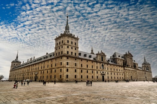 Side perspective view of the main façade and entrance of the monasteries of San Lorenzo de el Escorial, in the Herrerian style, in the community of Madrid.