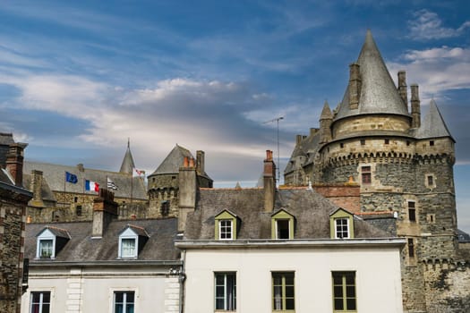 Partial view of the castle of the French town of Vitre on a sunny day with light clouds.