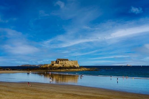 View of the beach du Sillon on a sunny summer day with the National Fort in the background in the medieval town of Saint Malo.