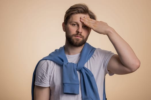 Face palm. Shame on you. Upset confused young man making face palm gesture, feeling bored uncertain, disappointed in result, bad news. Handsome guy isolated alone on beige studio background indoors