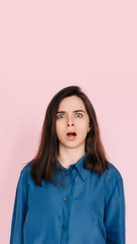 Stunning Portrait of a Speechless Woman in Utter Shock, Wide Open Mouth, Expressing Unbelievable Surprise - Isolated on Vibrant Pink Background.