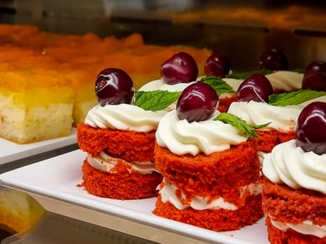 Mini cakes with berries and fruits close up. raspberry, blueberry and kiwi. delicious small tarts