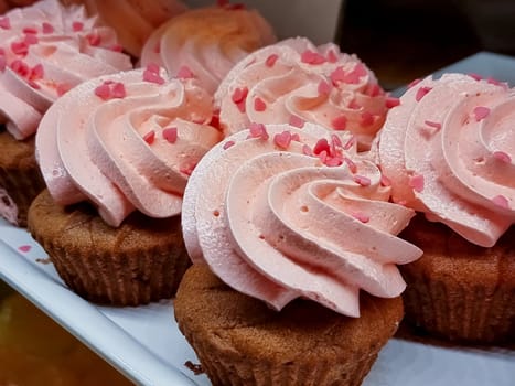 cupcakes with summer berries on blue wooden table