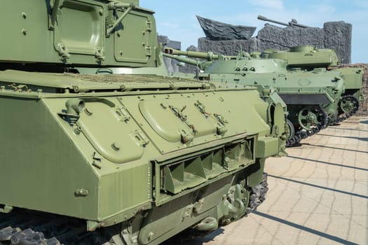 military armored vehicles behind a barbed wire fence. photo