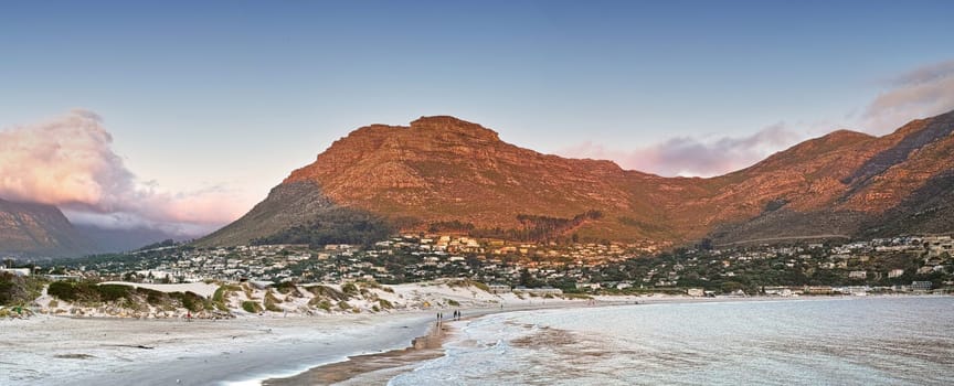 Mountain, nature and city by ocean in South Africa for tourism, traveling and global destination. Landscape, background and scenic view of beach by urban town for adventure, vacation and holiday.