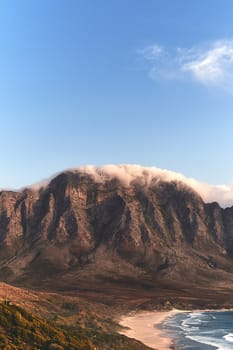 Admiring mother nature. a mountain range near the sea during a clear day outdoors