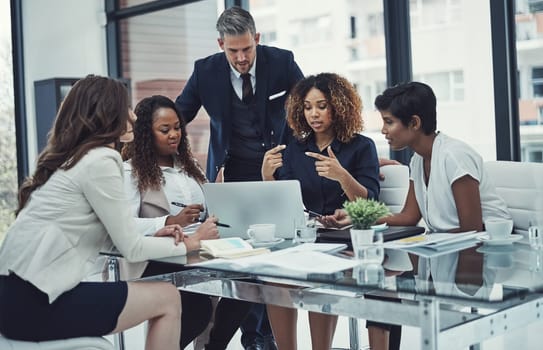 Effective communication is crucial for a successful collaboration. a group of colleagues having a meeting in a modern office