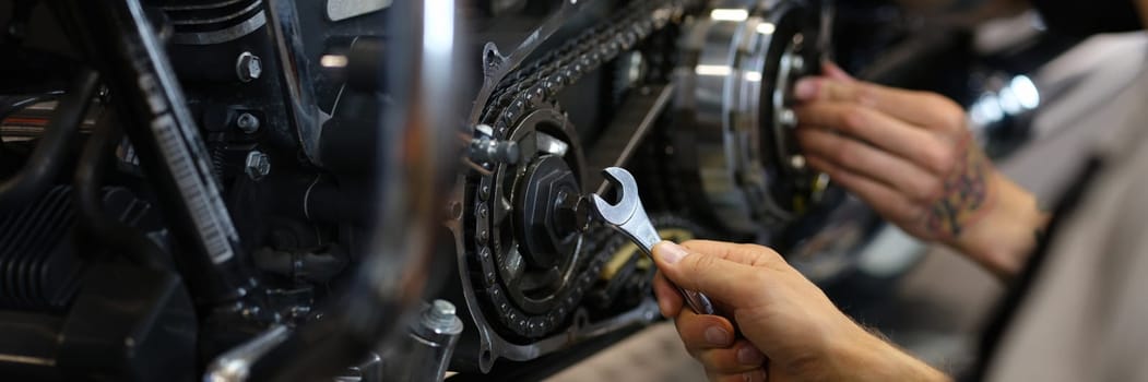 Maintenance of motorcycle engine clutch system by technicians. Repair and diagnostics of motorcycle engine breakdown concept