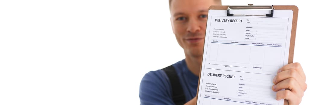 Delivery man holds clipboard with delivery receipt in hands. Courier logistics and delivery of goods concept