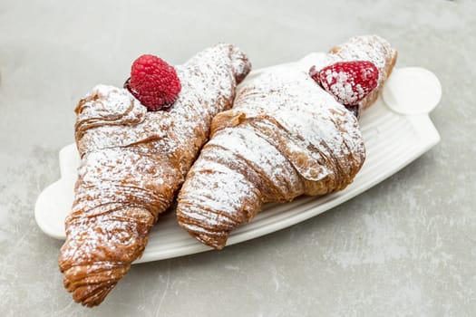 Croissants with jam and berries for Breakfast. Traditional Italian breakfast.