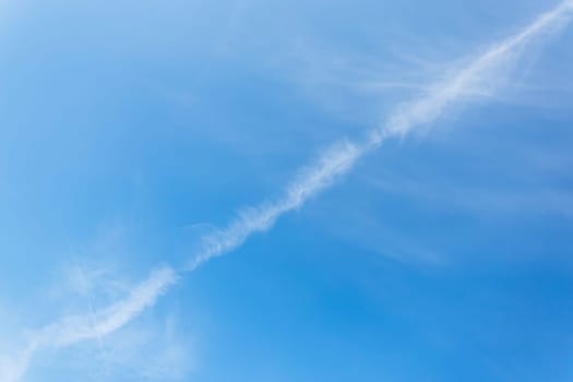 Trail line from a flying plane on a beautiful blue sky. Airplane trail. chemical trail in the sky from an aircraft.