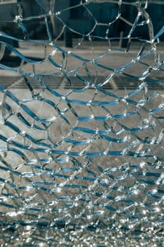 Shattered glass fills the close-up, no people in sight.