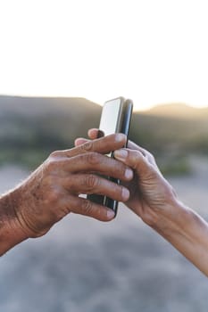 Whats mine is yours. an unrecognisable man and woman pairing their smartphones outdoors