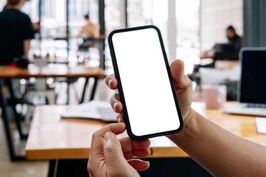 Man hand holding mockup image smart phone blank white screen for text. concept for modern communication in the business financial