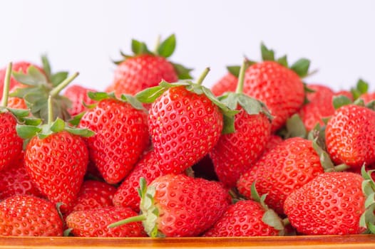 Beautiful and delicious strawberries in a wooden box basket, concept of organic farming, fresh direct delivery from orchard, close up.