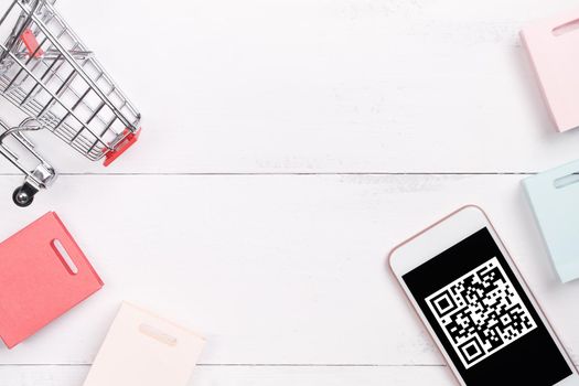 Abstract online shopping,mobile payment with QR code design concept element,colorful cart,paper bag on wooden table background,top view,flat lay