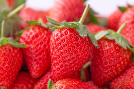 Beautiful and delicious strawberries in a wooden box basket, concept of organic farming, fresh direct delivery from orchard, close up.