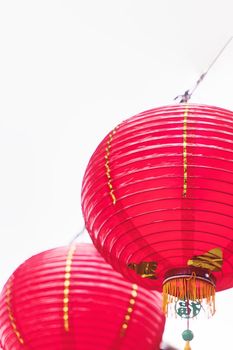 Beautiful round red lantern hanging on old traditional street, concept of Chinese lunar new year festival, close up. The undering word means blessing.