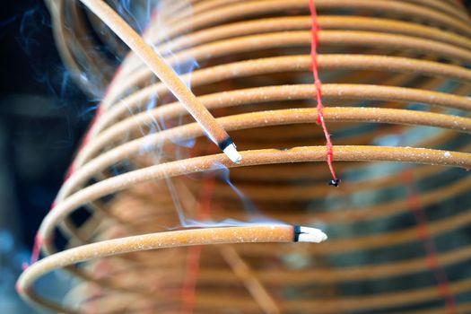 Burned coil swirl incense in Macau (Macao) temple, traditional Chinese cultural customs to worship god, close up, lifestyle.
