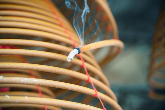 Burned coil swirl incense in Macau (Macao) temple, traditional Chinese cultural customs to worship god, close up, lifestyle.