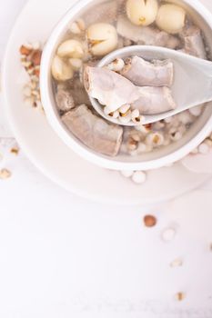 Tasty Four Tonics Herb Flavor Soup,Taiwanese traditional food with herbs,pork intestines on white wooden table,close up,flat lay,top view