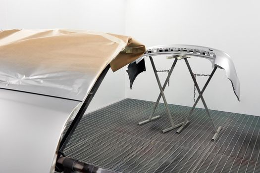 Painting And Drying In Professional Box Of Car Body Parts After Applying Putty And Paint On Bumper