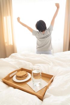 Tray with breakfast on a bed in a hotel room