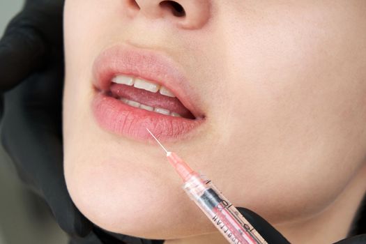 Beautiful woman gets an injection in lips