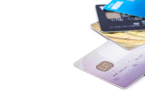 Selective focus of group of multi colored bank credit cards on white background.