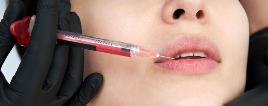 Beautiful woman gets an injection in lips
