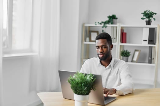 man computer office job indoor blank education businessman online american using laptop student freelancer male looking business space black internet programmer african smiling