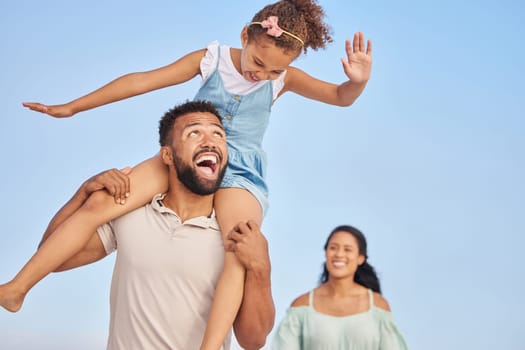 Smile, parents or kid walking on beach to relax on happy family holiday or fun summer vacation together. Lovely dad, shoulder or excited young girl bonding, smiling or enjoying quality time with mom.