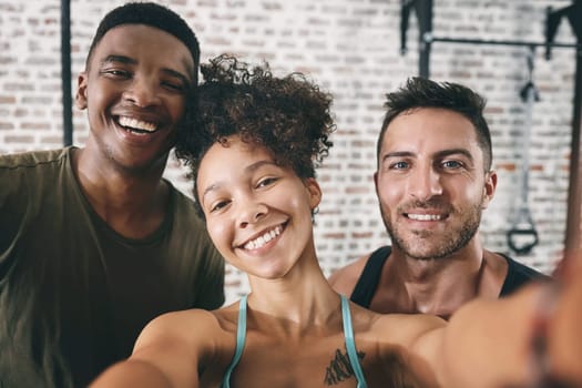 Another day at the gym with my fitness besties. three sporty young people taking a selfie at the gym