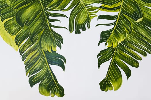 Tropical palm leaves are beautifully painted with acrylic paint in different shades of green