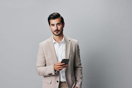 man happy smartphone adult portrait mobile holding young application suit technology trading beard isolated corporate hold smile call white business phone